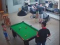 Kid casually does difficult shots on billiard